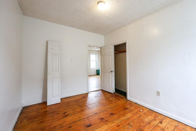37 Colton St, Worcester, MA 01610 - unfurnished bedroom with hardwood / wood-style floors, a textured ceiling, and a closet