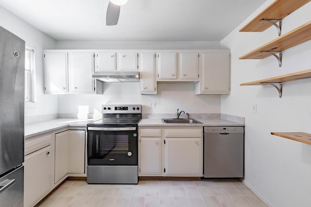 kitchen featuring appliances with stainless steel finishes, sink, white cabinets, and ceiling fan