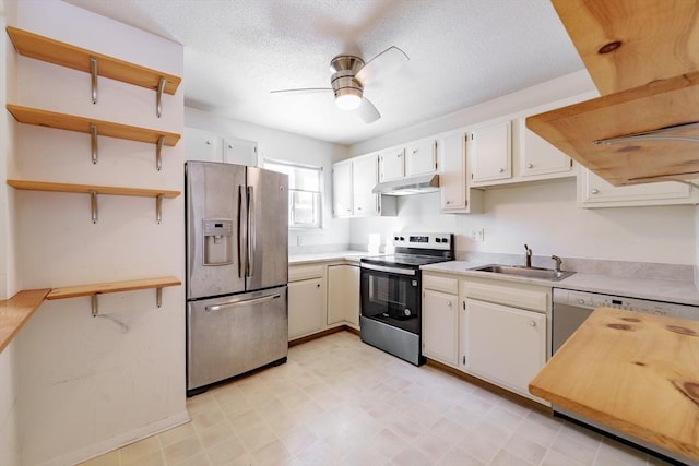 kitchen featuring sink, white cabinetry, a textured ceiling, ceiling fan, and stainless steel appliances