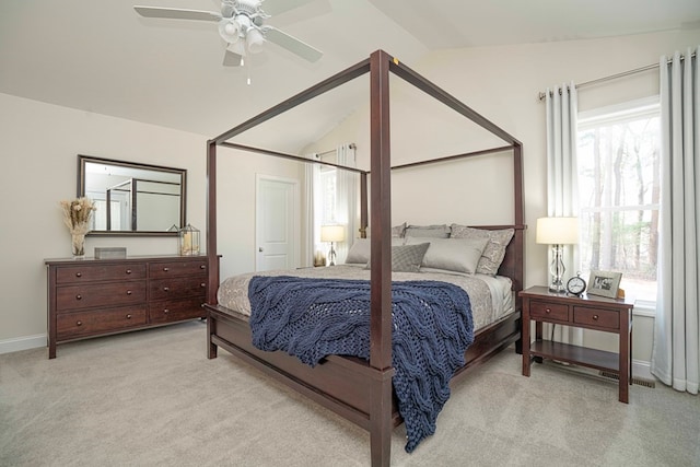 bedroom featuring light carpet, vaulted ceiling, and ceiling fan