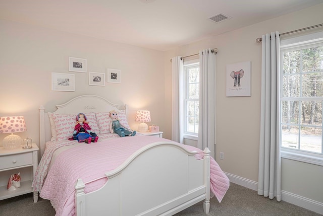 bedroom featuring dark colored carpet