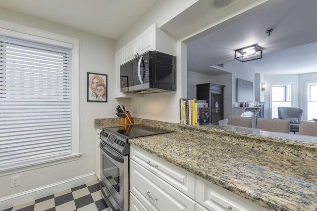 416 Commonwealth Ave Unit 212, Boston, MA 02115 - kitchen with black microwave, stainless steel electric stove, tile patterned floors, white cabinetry, and light stone countertops