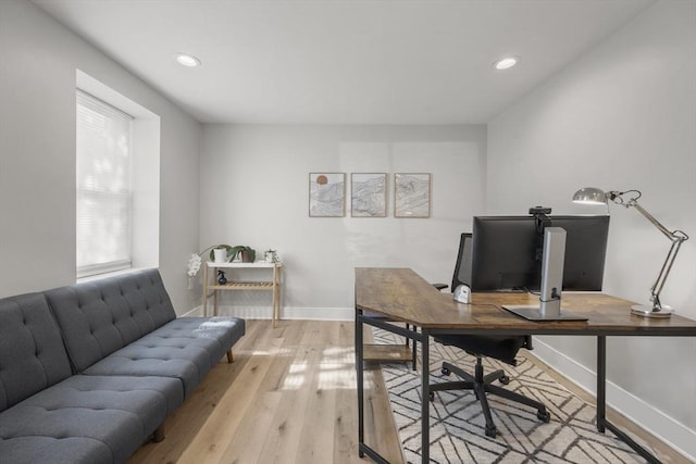 office featuring baseboards, recessed lighting, and light wood-type flooring