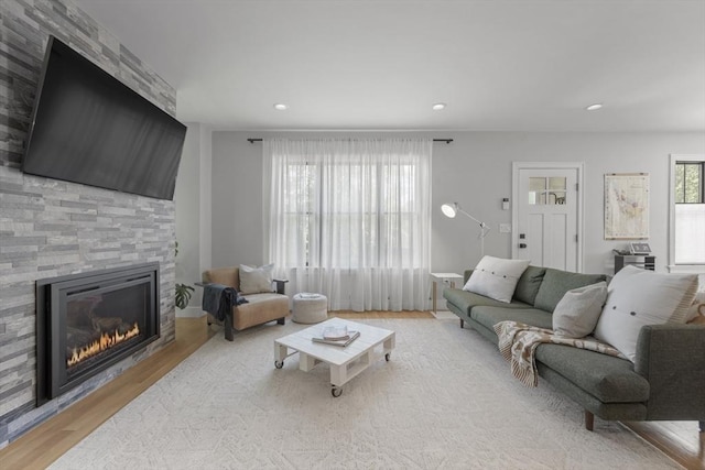 living room with a fireplace, recessed lighting, and wood finished floors