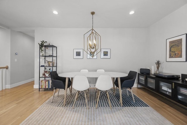 dining area with baseboards, light wood-style floors, a chandelier, and recessed lighting