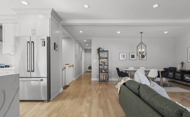living area with an inviting chandelier, light wood-type flooring, and recessed lighting