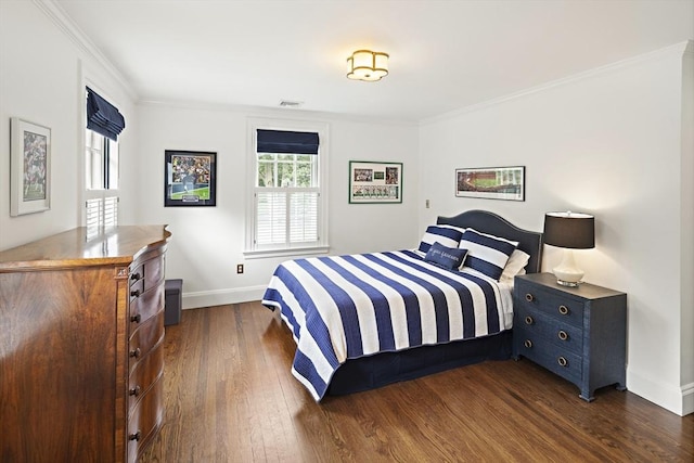 bedroom featuring dark wood-style floors, visible vents, ornamental molding, and baseboards