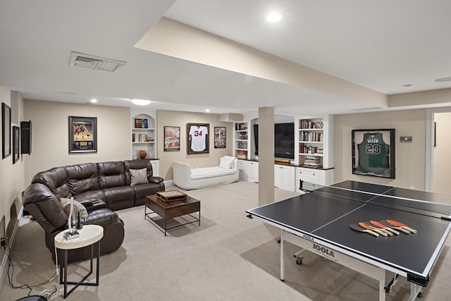 recreation room with light carpet, built in shelves, visible vents, and recessed lighting