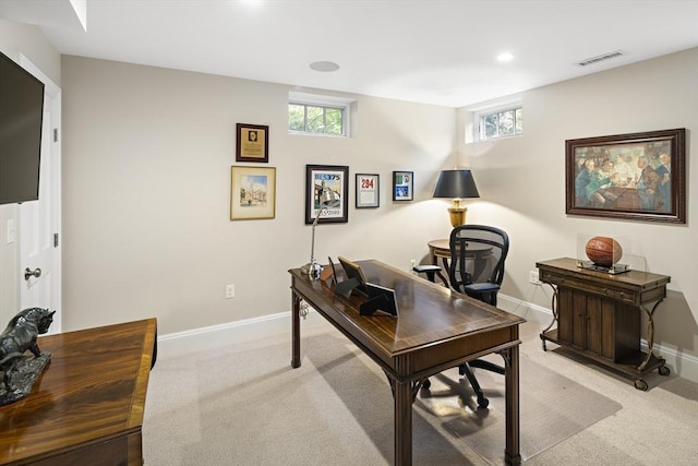 office with plenty of natural light, visible vents, baseboards, and light colored carpet