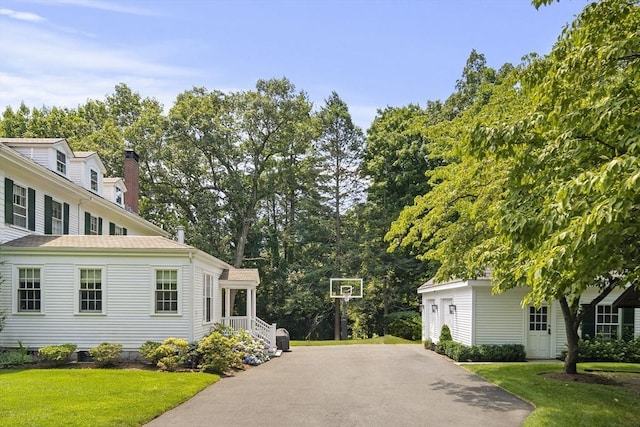 view of home's exterior featuring a yard and aphalt driveway