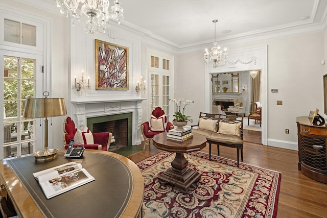 sitting room with crown molding, a fireplace with flush hearth, and a notable chandelier