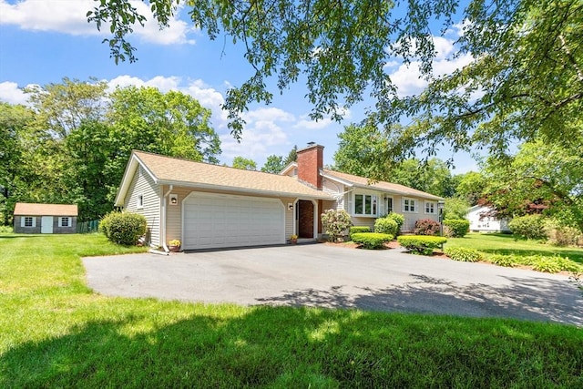 7 Gail St, Chelmsford, MA 01824 - view of front of house with asphalt driveway, an attached garage, a front yard, and a chimney