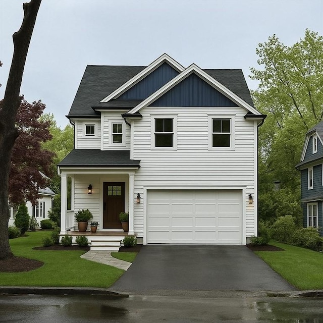 67 Pine St Unit 2, Dedham, MA 02026 - view of front of property featuring asphalt driveway, a garage, a front lawn, and a porch