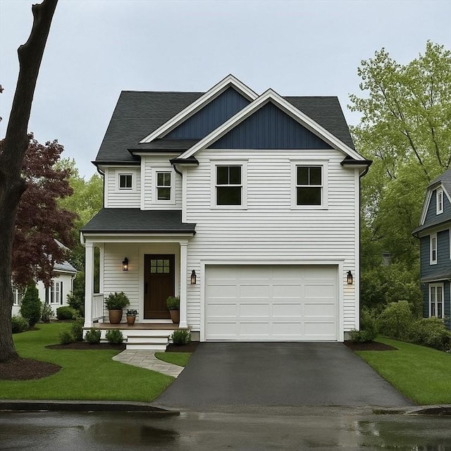 67 Pine St Unit 2, Dedham, MA 02026 - view of front of property with asphalt driveway, an attached garage, a front lawn, and a porch