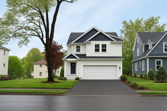 67 Pine St Unit 2, Dedham, MA 02026 - view of front of home featuring an attached garage, asphalt driveway, board and batten siding, and a front yard