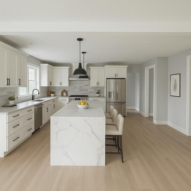 67 Pine St Unit 2, Dedham, MA 02026 - kitchen with appliances with stainless steel finishes, a sink, a center island, and decorative backsplash