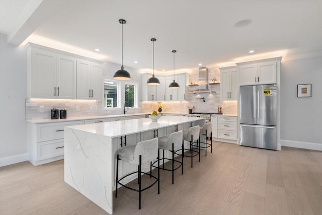 67 Pine St Unit 2, Dedham, MA 02026 - kitchen featuring freestanding refrigerator, island range hood, light wood-style flooring, backsplash, and recessed lighting