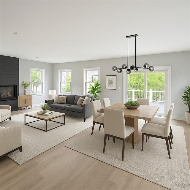 67 Pine St Unit 2, Dedham, MA 02026 - dining room with wood finished floors, a chandelier, baseboards, and a fireplace