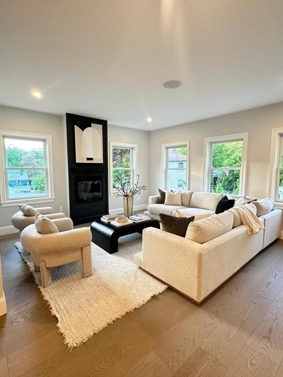 67 Pine St Unit 2, Dedham, MA 02026 - living room with wood finished floors, baseboards, and recessed lighting