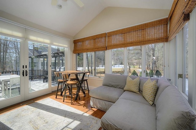 sunroom / solarium featuring lofted ceiling and ceiling fan