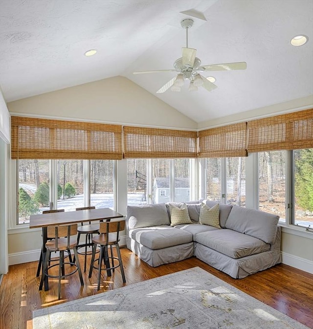 sunroom / solarium featuring lofted ceiling and ceiling fan