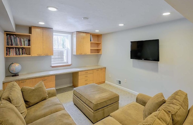 living room featuring recessed lighting, built in desk, visible vents, and baseboards