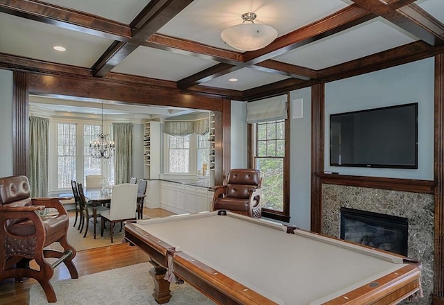 game room featuring wood finished floors, coffered ceiling, a high end fireplace, pool table, and beamed ceiling