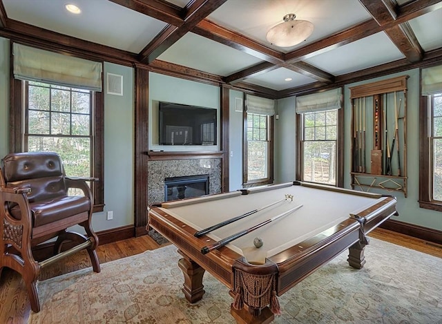 rec room featuring wood finished floors, baseboards, coffered ceiling, a high end fireplace, and beamed ceiling