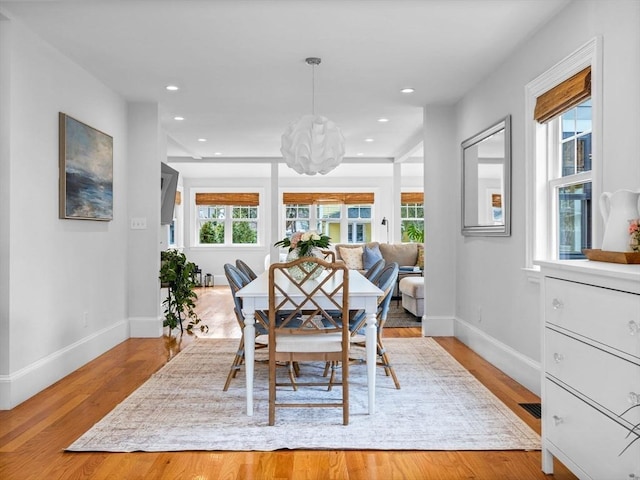 dining room with baseboards, light wood finished floors, visible vents, and recessed lighting