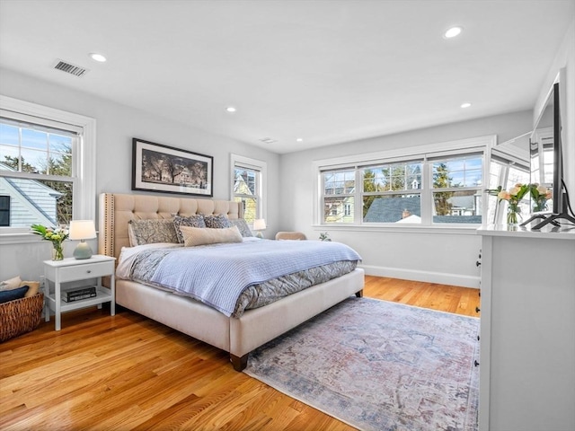 bedroom featuring light wood-style floors, baseboards, visible vents, and recessed lighting