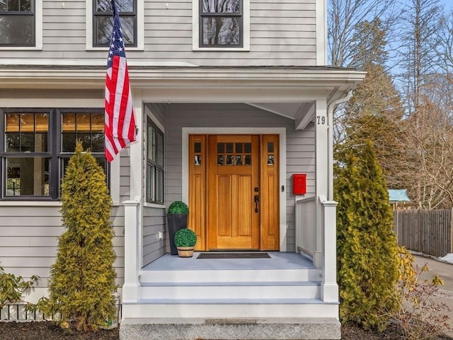 entrance to property featuring fence