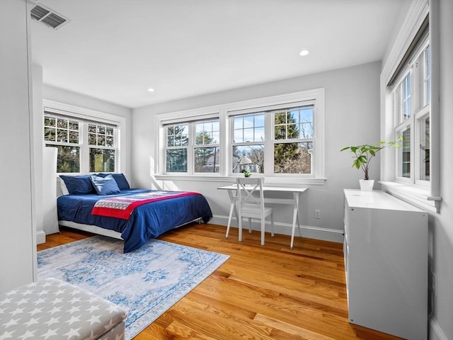 bedroom with light wood finished floors, baseboards, visible vents, and recessed lighting