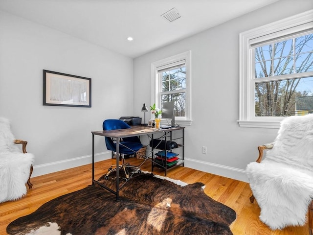 home office with recessed lighting, wood finished floors, visible vents, and baseboards