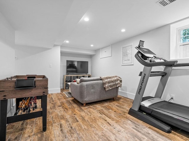 exercise area featuring recessed lighting, visible vents, baseboards, and wood finished floors