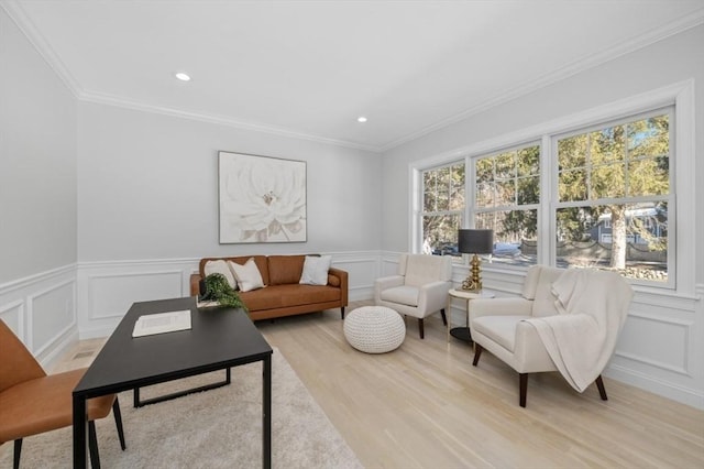 living room featuring ornamental molding and light hardwood / wood-style flooring