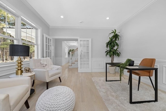 living area featuring ornamental molding and light hardwood / wood-style floors