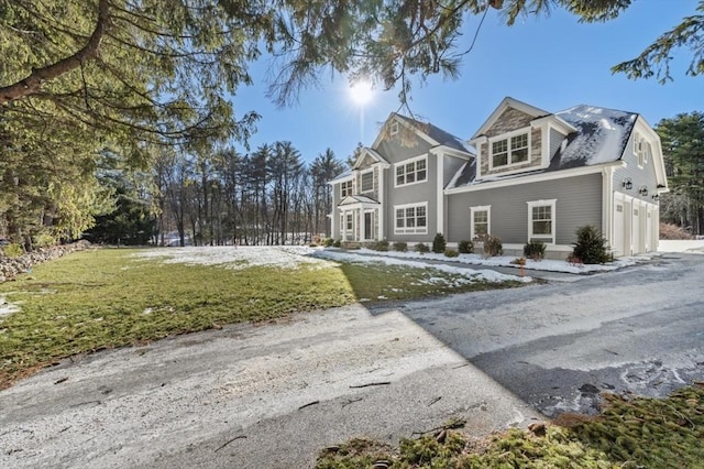 view of front of house with a garage and a front lawn