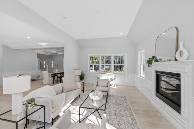 living room featuring vaulted ceiling and light wood-type flooring