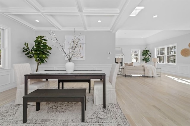 dining room with coffered ceiling, beam ceiling, and light wood-type flooring