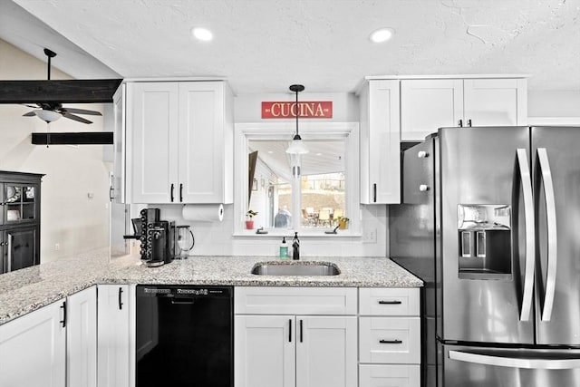 kitchen featuring dishwasher, stainless steel fridge, white cabinetry, and a sink