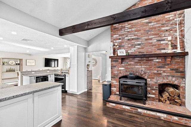 kitchen featuring light stone countertops, stainless steel electric stove, lofted ceiling with beams, dark wood-style floors, and white cabinetry