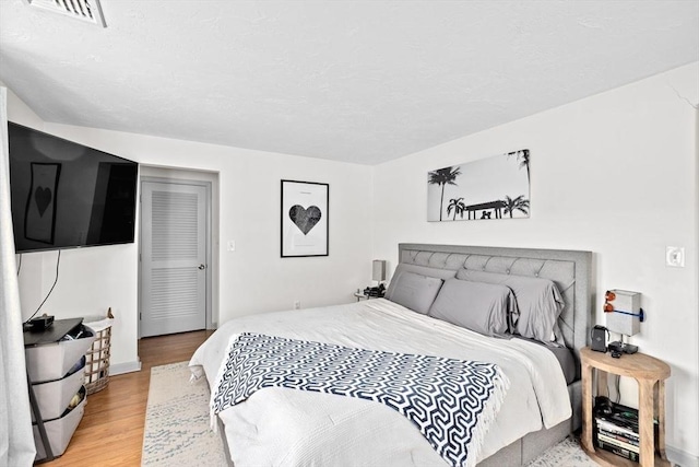 bedroom with visible vents and light wood finished floors