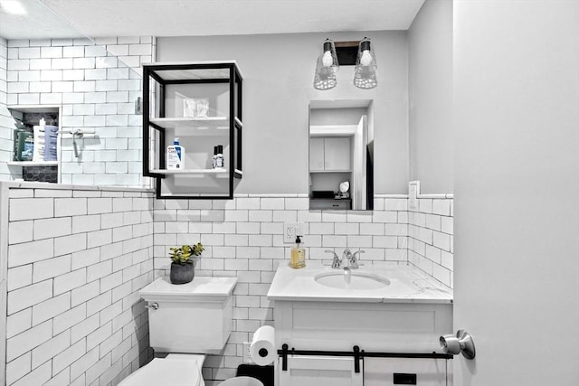 bathroom with vanity, tile walls, and toilet