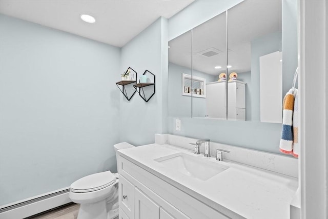 half bathroom featuring visible vents, toilet, a baseboard heating unit, recessed lighting, and vanity