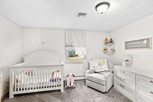 bedroom with visible vents, carpet floors, a nursery area, and a textured ceiling