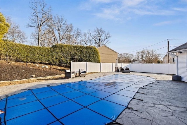 view of swimming pool with a patio area, a fenced backyard, and a fenced in pool