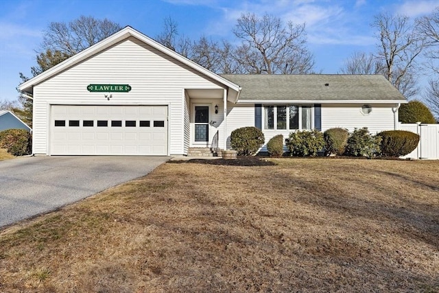 ranch-style home featuring aphalt driveway, an attached garage, a front yard, and fence