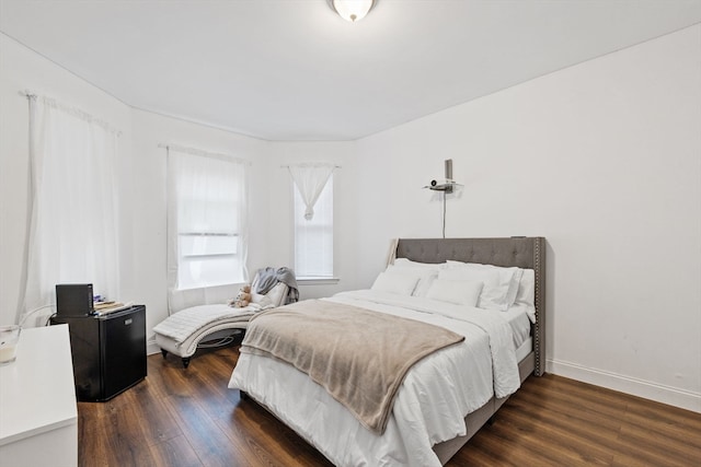 bedroom with dark hardwood / wood-style floors