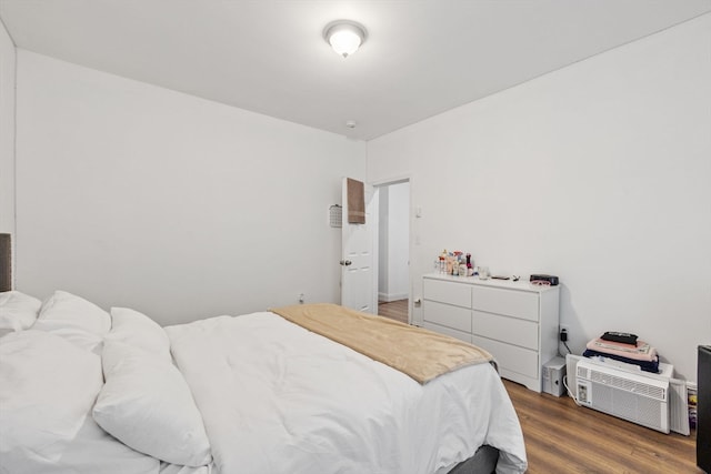 bedroom with dark hardwood / wood-style flooring