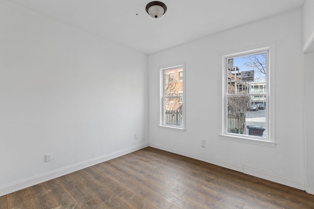 spare room with dark wood-type flooring